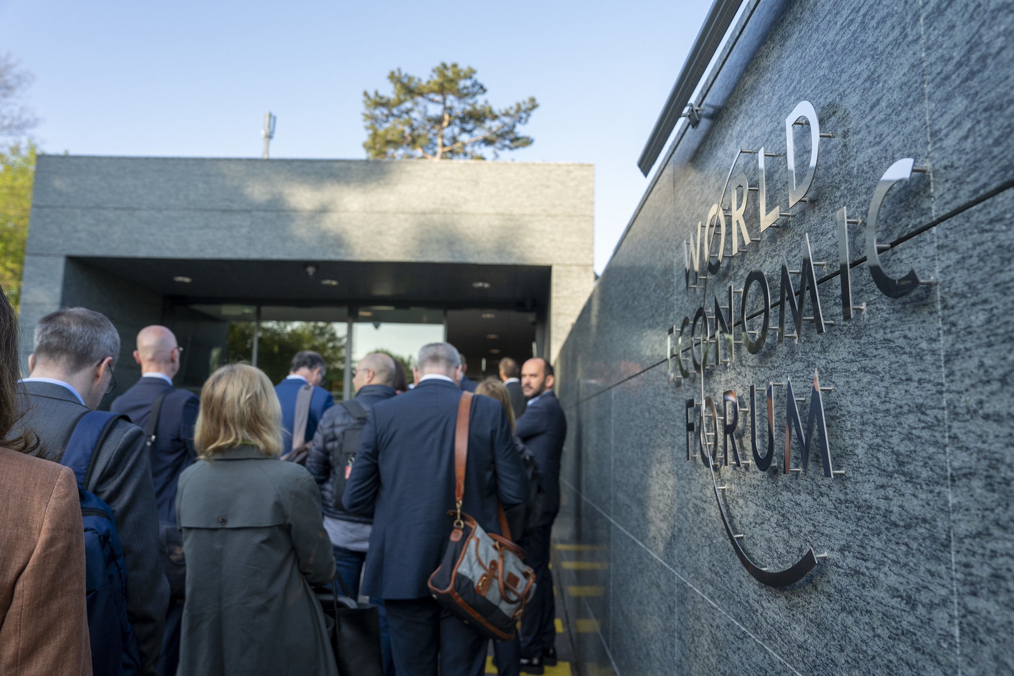 The World Economic Forum logo on a wall